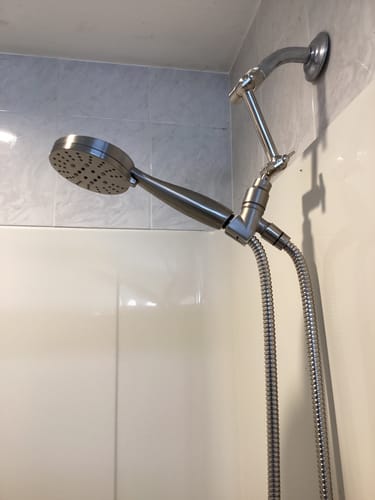 Customer's installed metal 3-Spray Handheld Shower Head on an adjustable arm in a tiled shower.