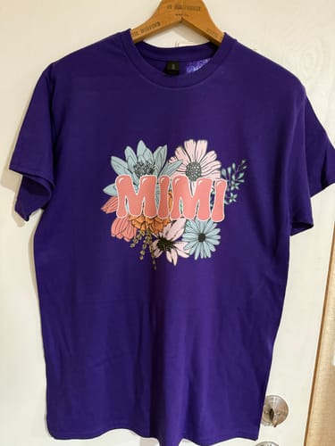 Reviewer's purple shirt with a colorful floral 'MIMI' design made with the DTF Super Soft Powder.