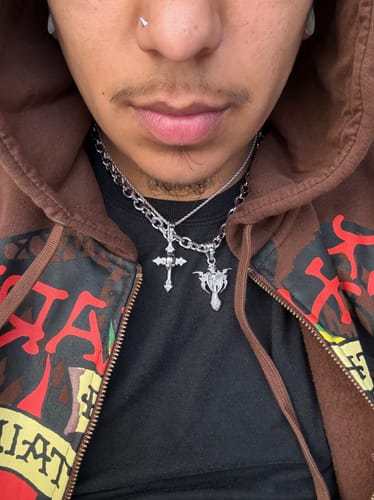 Close-up of a reviewer wearing the silver 8MM MINI ARIES CHAIN with pendants over a black shirt.