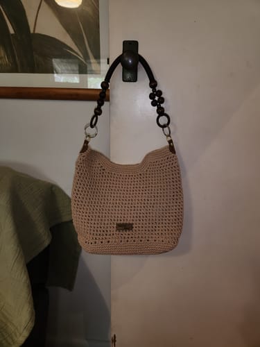 Reviewer's completed beige CrochetPark™ Sunny Beach Tote hanging from a hook on a door.