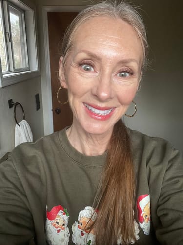 A smiling reviewer with fair skin shows off her natural-looking Chocolate Fluffy Lite Gossamer® Lashes.