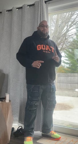 Reviewer in a full-length photo wearing the blue wash Dropcut Stacked Denim, showing off the multiple pockets.