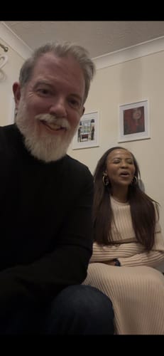 A reviewer and a woman reacting with joy while listening to their custom CREATE YOUR MELODY song.