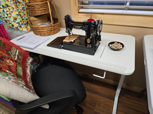 Customer's white Gidget I Sewing Table set up with a vintage black sewing machine fitting in the recessed platform.