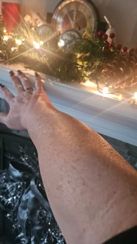 Reviewer's arm with hydrated, glowing skin after using the Body Serum.