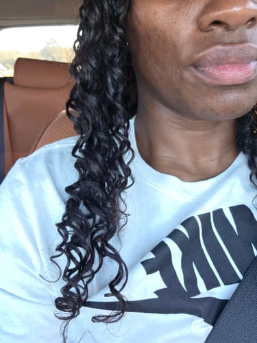 Close-up of a reviewer's soft, wavy Feather Crochet Boho Hair installed.