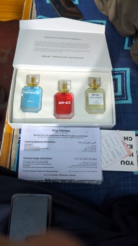 Customer's unboxing of a Zing fragrance set, showing three colorful bottles in a white box.