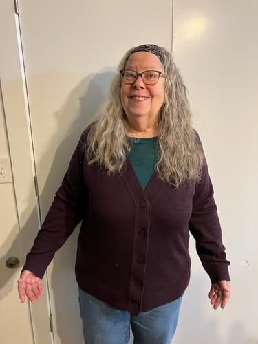 Reviewer showing the fit of the size 1X Gia Sweater in Deep Plum.