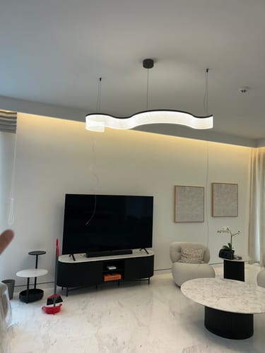 Customer's elegant Warm Glow Pendant Lamp installed in a modern living room above a television.