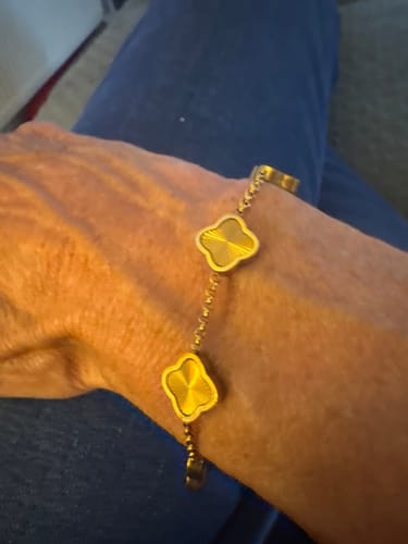 Customer showing the textured gold Celine Clover Bracelet on their wrist.