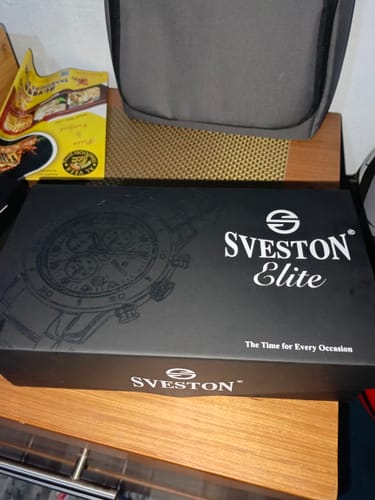 Customer's black Sveston Elite box for the John Wick Chain watch sitting on a wooden surface.