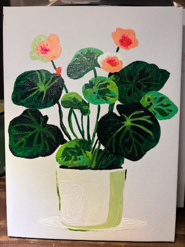 Customer's finished mini painting of a leafy green plant with small orange flowers in a light green pot.