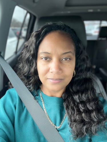 Customer sits in a car wearing long, wavy Loose Deep Wave Human Crochet Hair.