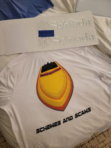 Customer's custom boat artwork of a yellow Schiada boat printed on the back of a white shirt.