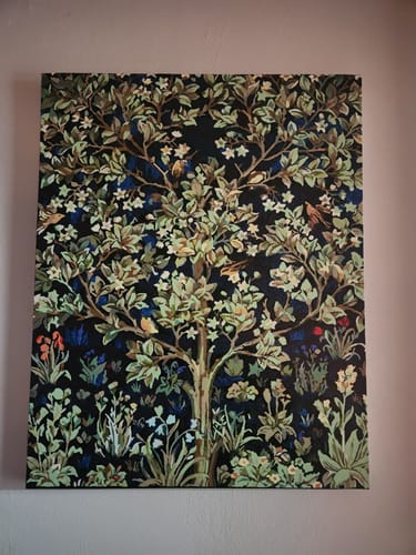 Reviewer's completed Tree of Life paint-by-numbers project hanging on a wall. The intricate painting has a dark background.