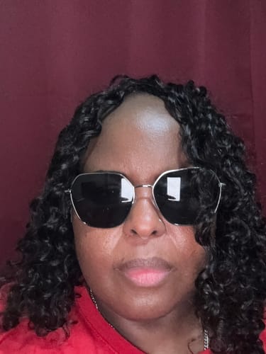 Reviewer's selfie showing a full, natural-looking install of the Human Crochet Hair Deep Wave.