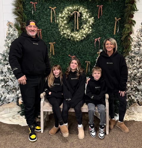 Customer's family of five posing together in matching black Oversized Hoodies.