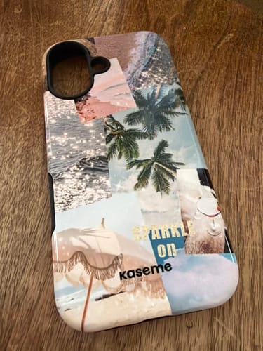 Customer's Island girl phone case shown with its colorful, tropical collage design on a wooden surface.