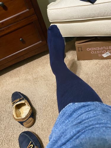 Customer wearing the blue Performance Eucalyptus Compression Socks in their room.