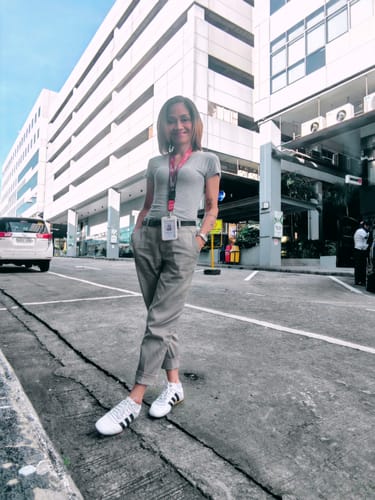 Reviewer standing outdoors wearing the white adidas Grand Court Lo shoes with casual grey trousers and a t-shirt.