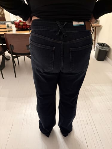 Reviewer showing the back fit of the dark wash Judy Blue Straight Leg Jeans in a home setting.
