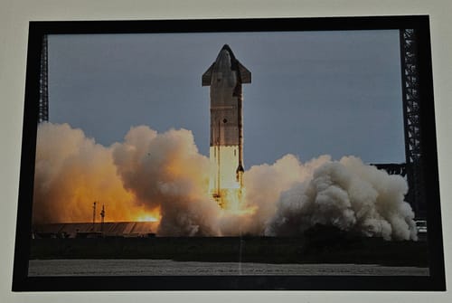 Customer's framed 'Ship 29 Awakes' print showing the rocket launch amidst fire and smoke.