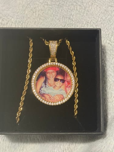 Customer's Diamond Studded Photo Necklace with a round photo pendant, shown inside its black gift box.