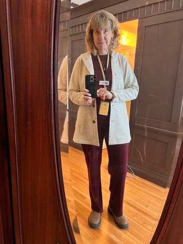 Reviewer in a mirror selfie wearing the Edna Hooded Cardigan open over a burgundy shirt and pants indoors.
