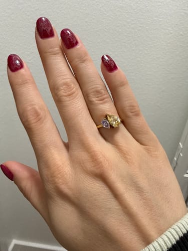 Customer wearing the Leesha Birthstone Ring with yellow and light purple pear-shaped stones.