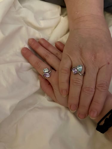 Customer showing two Navae Birthstone Rings being worn, each with light purple and light blue stones.