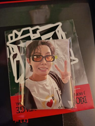 Close-up of a J-Hope photocard and sticker sheet from the customer's HOPE ON THE STAGE THE ORIGINAL SET.