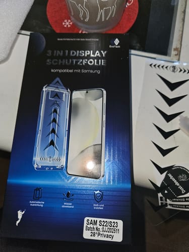 Rezensent zeigt die Verpackung der 3 in 1 Schutzfolie für Samsung.