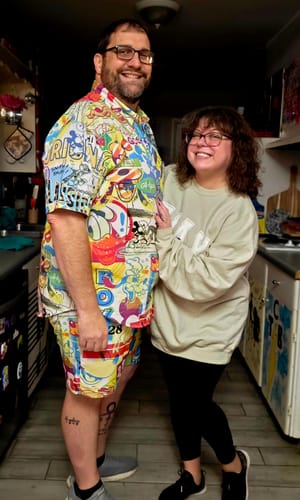 Customer wearing the Disney 'Pop Art Party' Hybrid Shorts and matching shirt together as a colorful set.