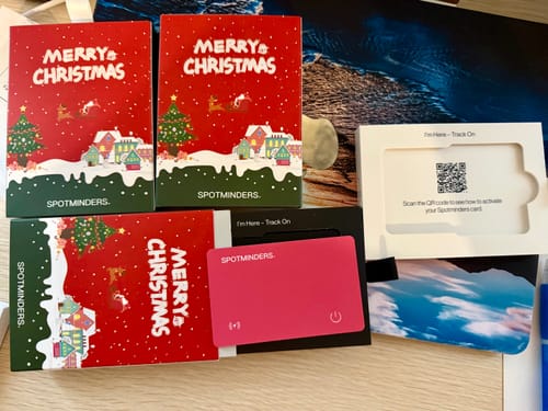 Customer's pink SPOTMINDERS. Tracking Card displayed with its festive Christmas sleeves and activation packaging.