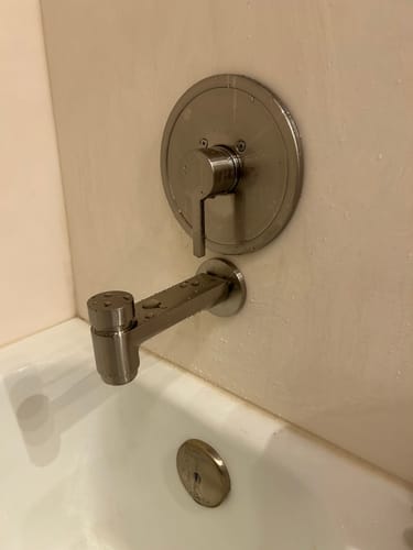 Reviewer's installed Tub Spout in a brushed metal finish, showing the push-down diverter.