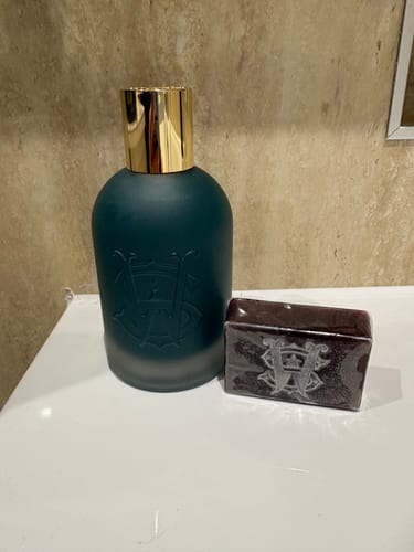 Customer's Brown Sugar perfume in a dark teal bottle with a gold cap, shown next to a matching bar of soap.