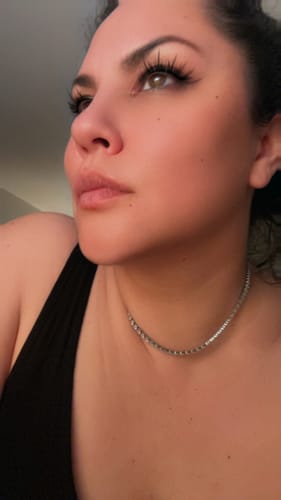 Close-up of a reviewer wearing the silver Monaco Tennis Necklace.