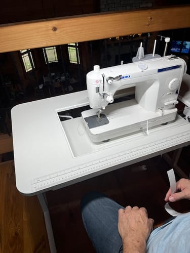 Customer's white Gidget II Sewing Table with a sewing machine and clear insert, creating a flush work surface.