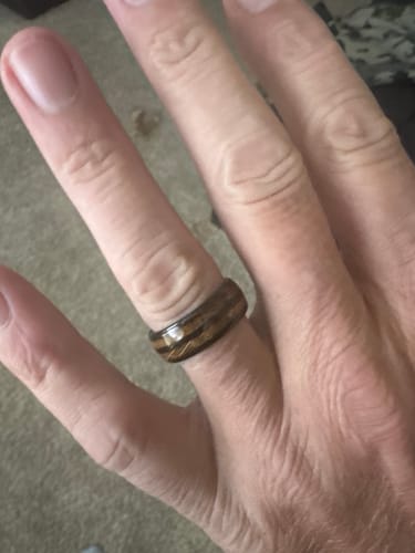 Close-up of a customer's hand wearing their new patterned replacement ring.