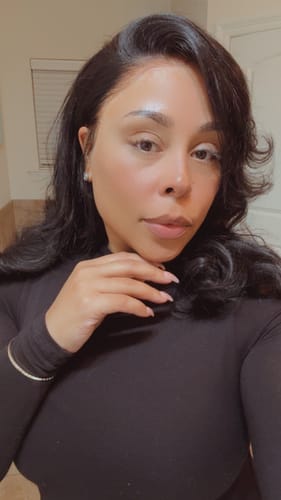Close-up of a reviewer wearing the fitted, long-sleeved NW Sculpt Mock Neck Bodysuit.