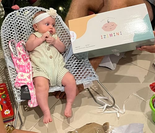Packaging for the Sailor baby chair shown next to a baby sitting in a different chair.