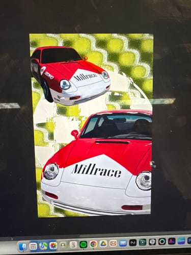 Reviewer's digital painting of two race cars, showing a smudged effect created with the Displacecraft PS Plugin.