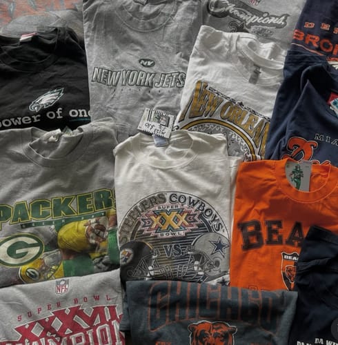 Customer's photo of the assorted vintage-style shirts included in their wholesale pack.