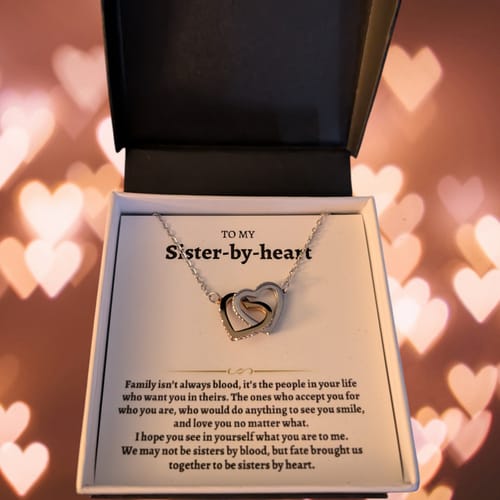 Reviewer's open gift box showing the Interlocked Hearts necklace and 'To My Sister-by-heart' card.