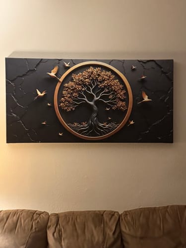 Customer's black and bronze Tree of Life canvas hanging on a wall above a couch.