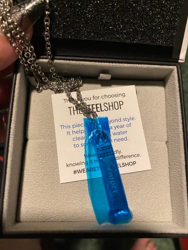 Customer's new Rectangle Bar Urn Pendant in its presentation box with the blue protective film still on.