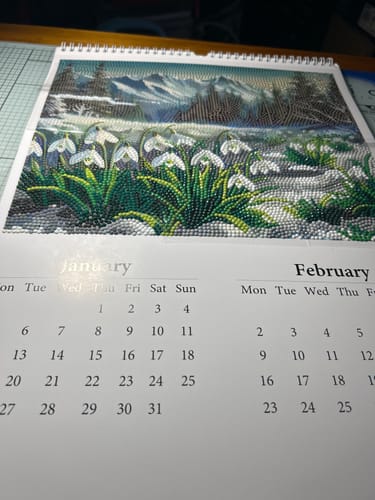 Reviewer's finished January page of the Crystal Art Calendar Kit, showing a sparkly image of snowdrops and mountains.