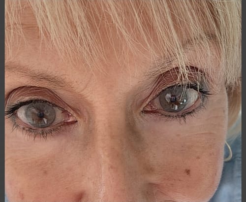 A customer's close-up of Hidrocor Graphite Gray contact lenses showing a light gray color over brown eyes.