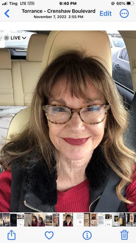 A smiling reviewer shows off her natural-looking Curl Core Gossamer® Lashes while sitting in a car.