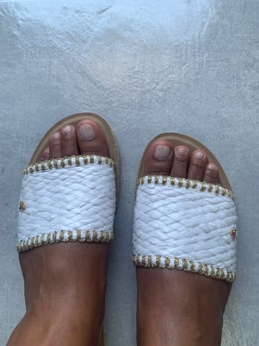 Customer's top-down view of their Butterfly Feet Zina 22 Sandals, showing the white raffia straps and gold trim.